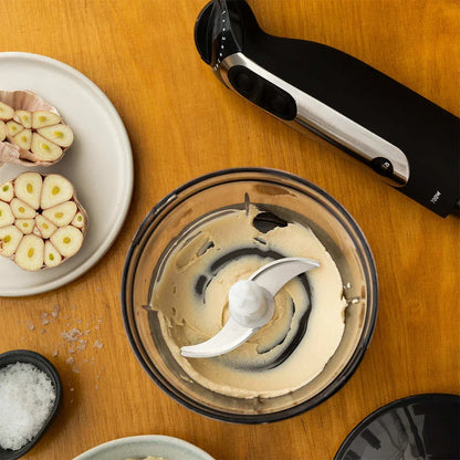 Mixing bowl with blade attachment and immersion blender over bowl